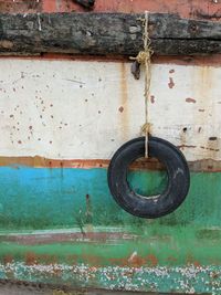 Close-up of rusty metal hanging against wall