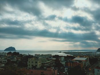 Cityscape against cloudy sky