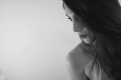 Close-up of young woman against white background