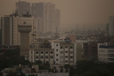 High angle view of buildings in city against sky
