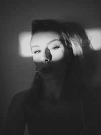 Portrait of young woman in darkroom