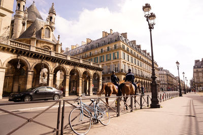 Bicycles on street against buildings in city