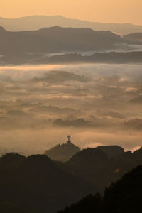 Scenic view of silhouette mountains against sky at sunset