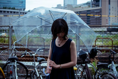 Woman standing with umbrella