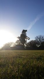 Scenic view of grassy field against sky