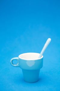 Close-up of drink on table against blue background