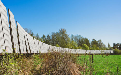 Scenic view of field against clear blue sky