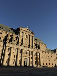 Low angle view of historical building against clear blue sky