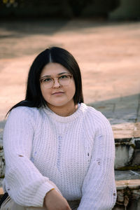 Portrait of smiling young woman standing outdoors