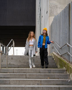 Full length of woman standing on steps