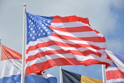 Low angle view of flag flags against sky