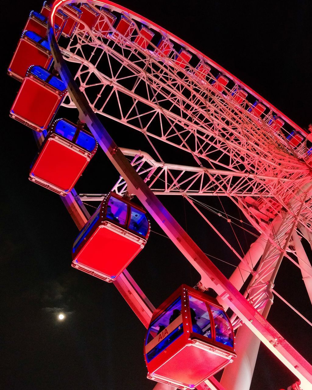LOW ANGLE VIEW OF FERRIS WHEEL AGAINST SKY AT NIGHT