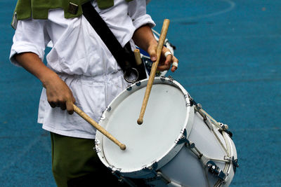 Low section of man playing guitar