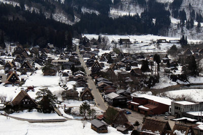 High angle view of snow covered trees and buildings