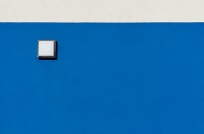 Close-up of light on blue wall