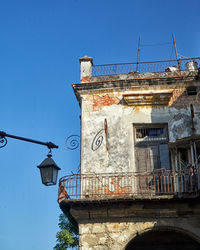 Low angle view of old building against clear blue sky