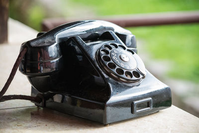 Close-up of old telephone on table