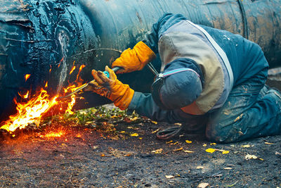 Man working on bonfire