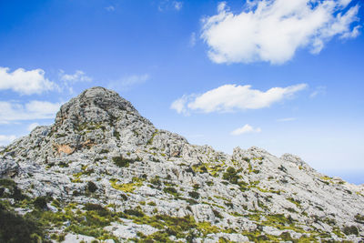 Low angle view of rock formation against sky