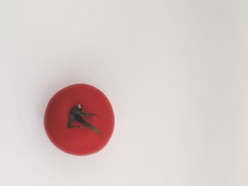 Close-up of red balloon over white background