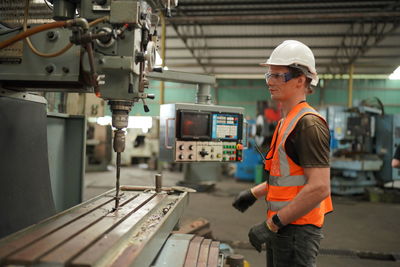 Rear view of man working at construction site