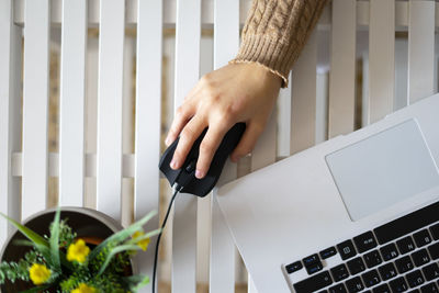 Woman using black mouse in the office.