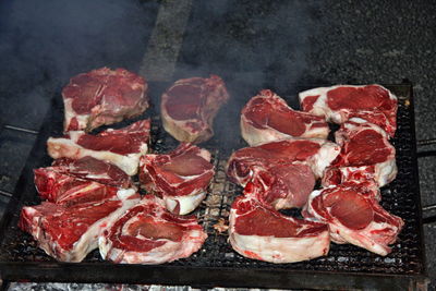 High angle view of meat on barbecue grill