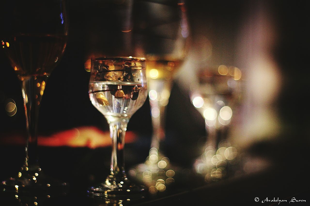 indoors, wineglass, transparent, glass - material, drinking glass, illuminated, focus on foreground, close-up, alcohol, night, refreshment, food and drink, wine, drink, no people, still life, freshness, reflection, glass, selective focus