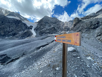 Road sign against mountain