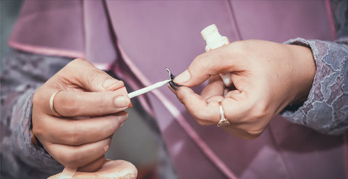 Close-up of hand holding eye lashes