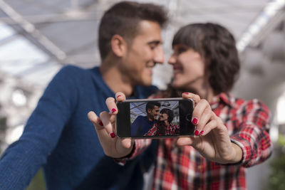 Smiling couple taking selfie