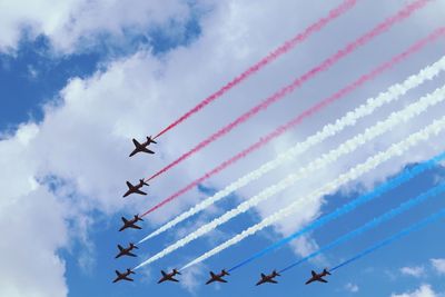 Low angle view of airshow against sky