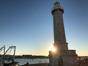 Low angle view of tower against sky during sunset