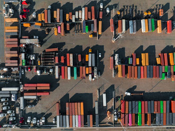 The oakland outer harbor aerial view. loaded trucks moving by container cranes.