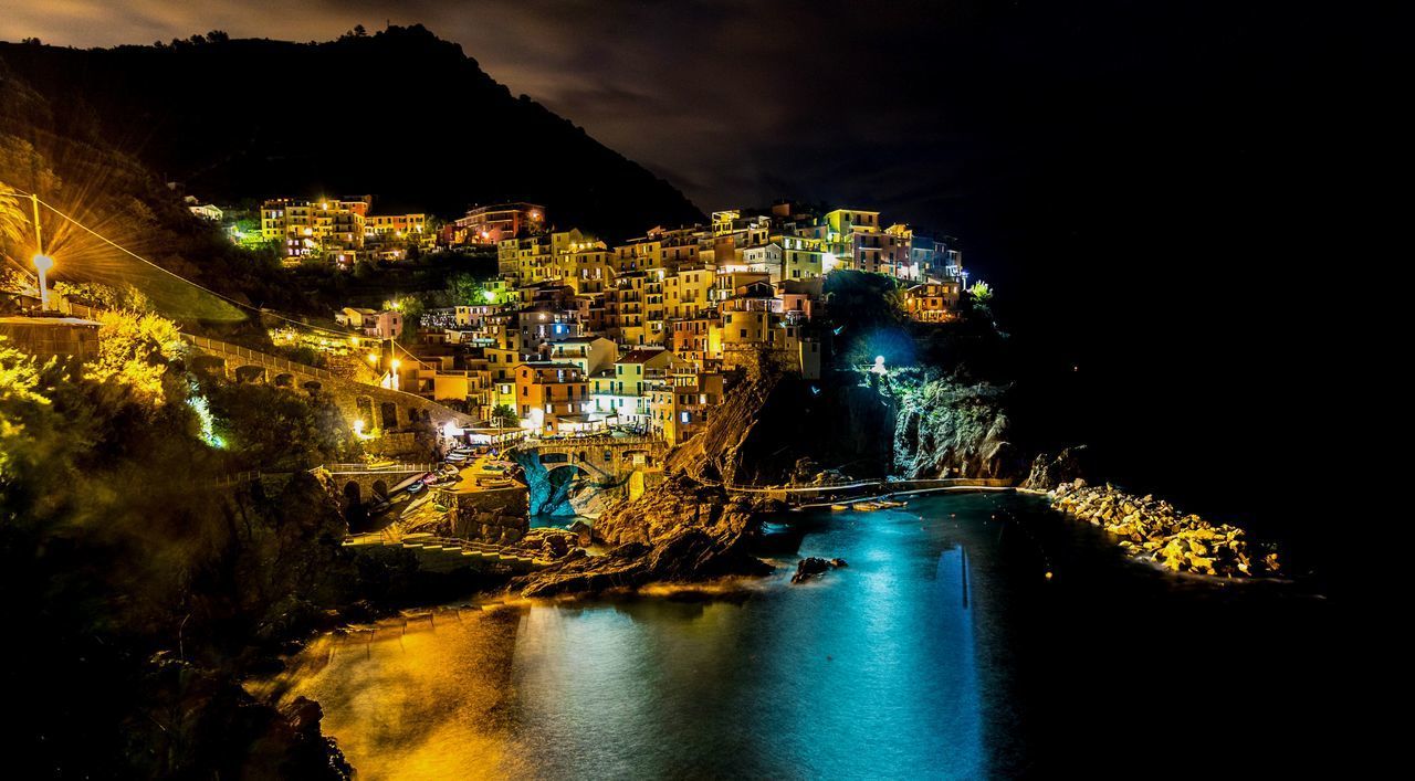 ILLUMINATED BUILDINGS IN CITY AT NIGHT