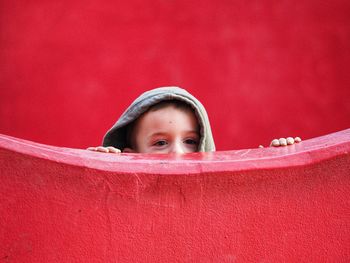 Portrait of boy in red water