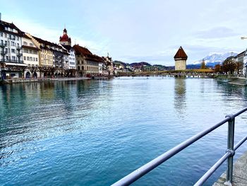 Bridge over river against buildings in city