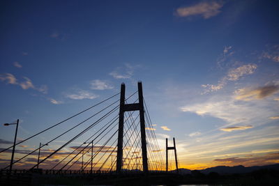 Low angle view of silhouette bridge against sky during sunset