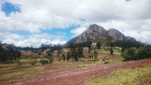 Scenic view of mountains against cloudy sky