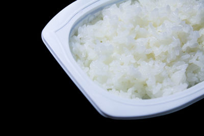 Close-up of food in bowl against black background