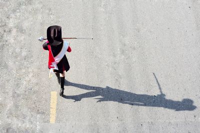 High angle view of woman walking on road