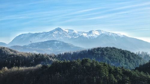 Scenic view of snowcapped mountains against blue sky