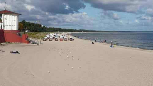 People on beach against sky