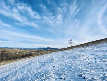 Snow covered land road against sky