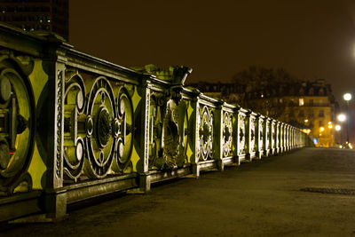 Illuminated bridge against sky in city at night