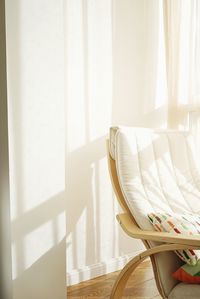 Close-up of curtain on bed against window at home