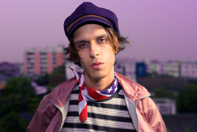 Portrait of young man standing against sky