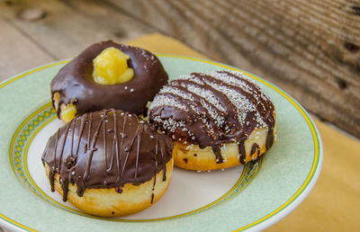 Close-up of chocolate donuts in plate on table