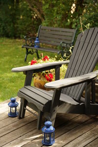 Deck chair in the seasonal garden. muskoka chair - summer colors and soft focused background.