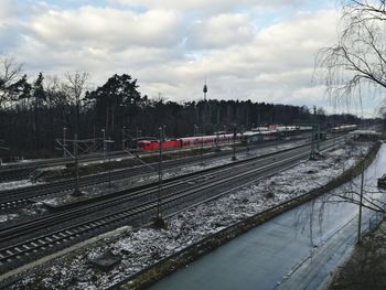 Railroad tracks against sky during winter